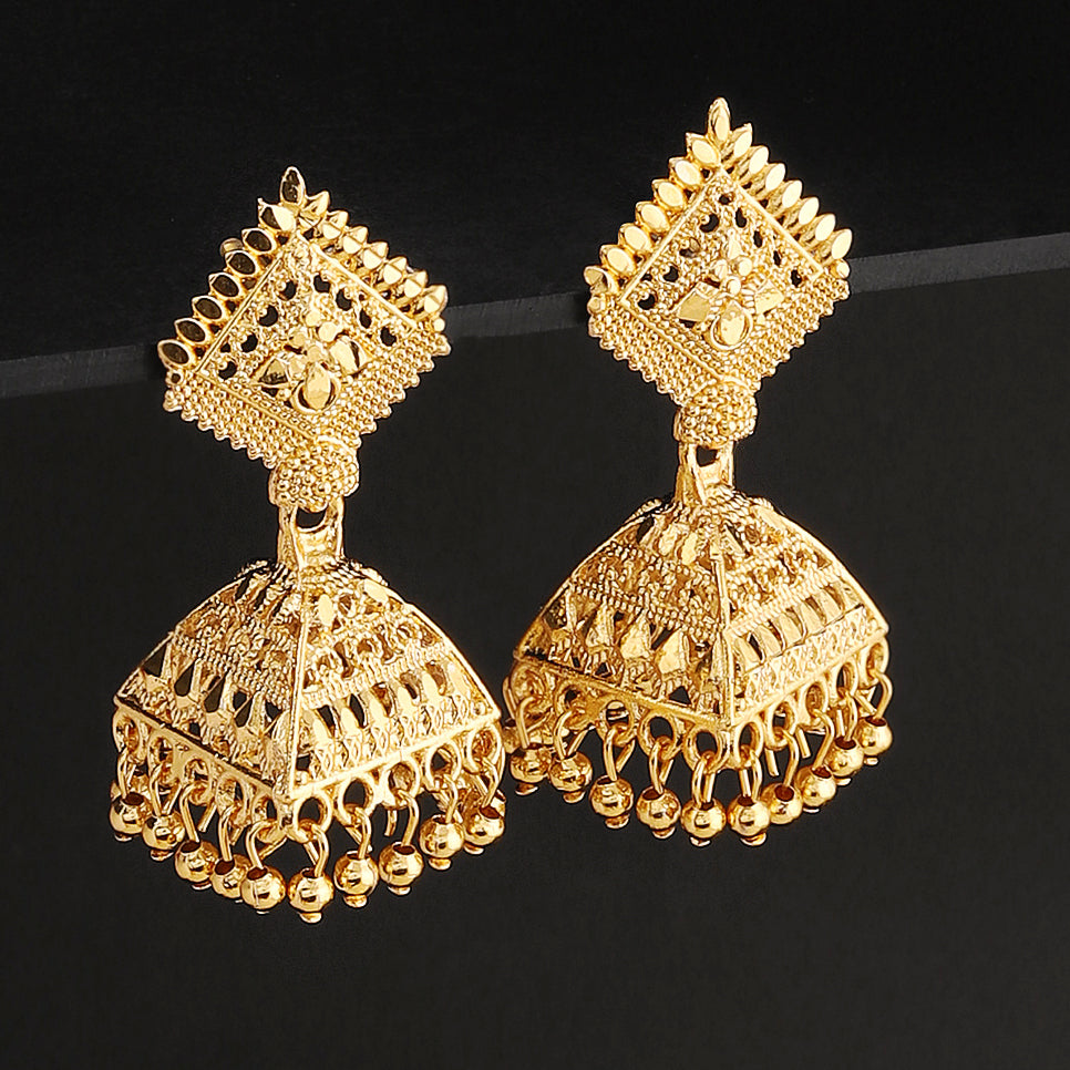 A pair of intricately designed gold-plated jhumka earrings from the Mekkna brand, featuring detailed craftsmanship and a luxurious finish.