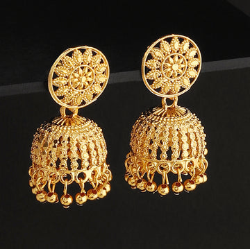 A pair of intricately designed gold-plated jhumka earrings from the Mekkna brand, featuring detailed craftsmanship and a luxurious finish.