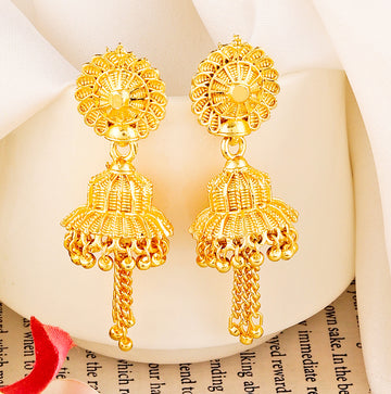 A pair of intricately designed gold-plated jhumka earrings from the Mekkna brand, featuring detailed craftsmanship and a luxurious finish.