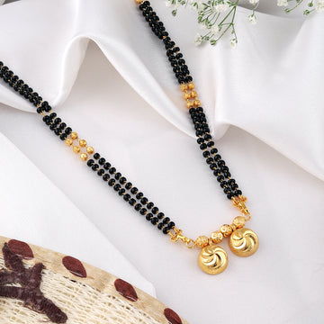 Elegant gold-plated mangalsutra from Mekkna, featuring a delicate chain with intricately designed beads and a striking pendant.